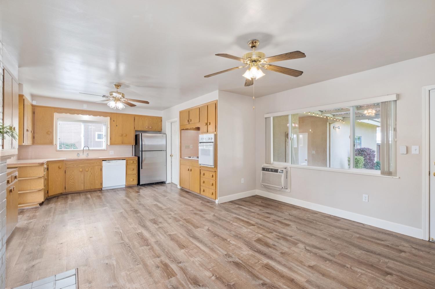 1223 Cyrier Avenue Reedley, CA 93654 - Photo 5 of 21 a view of a kitchen with wooden floor and a kitchen