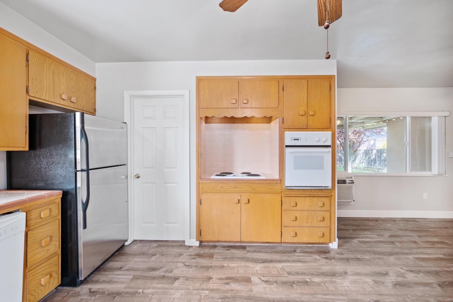 1223 Cyrier Avenue Reedley, CA 93654 - Photo 6 of 21 a view of a kitchen with wooden floor