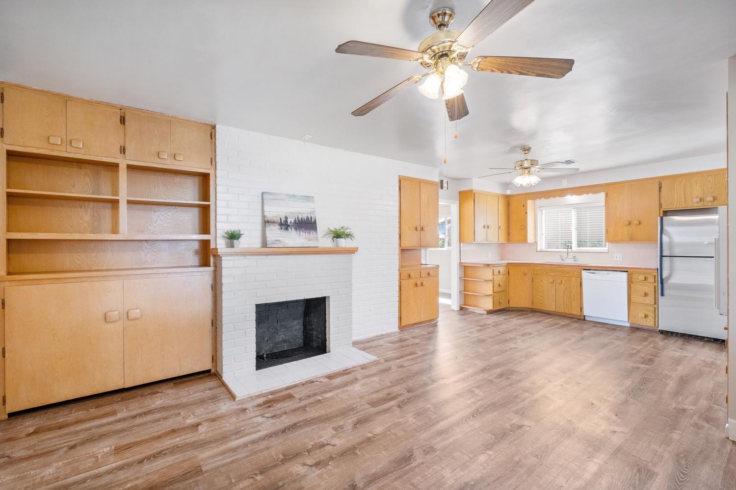 1223 Cyrier Avenue Reedley, CA 93654 - Photo 7 of 21 a view of an empty room with a fireplace and a window