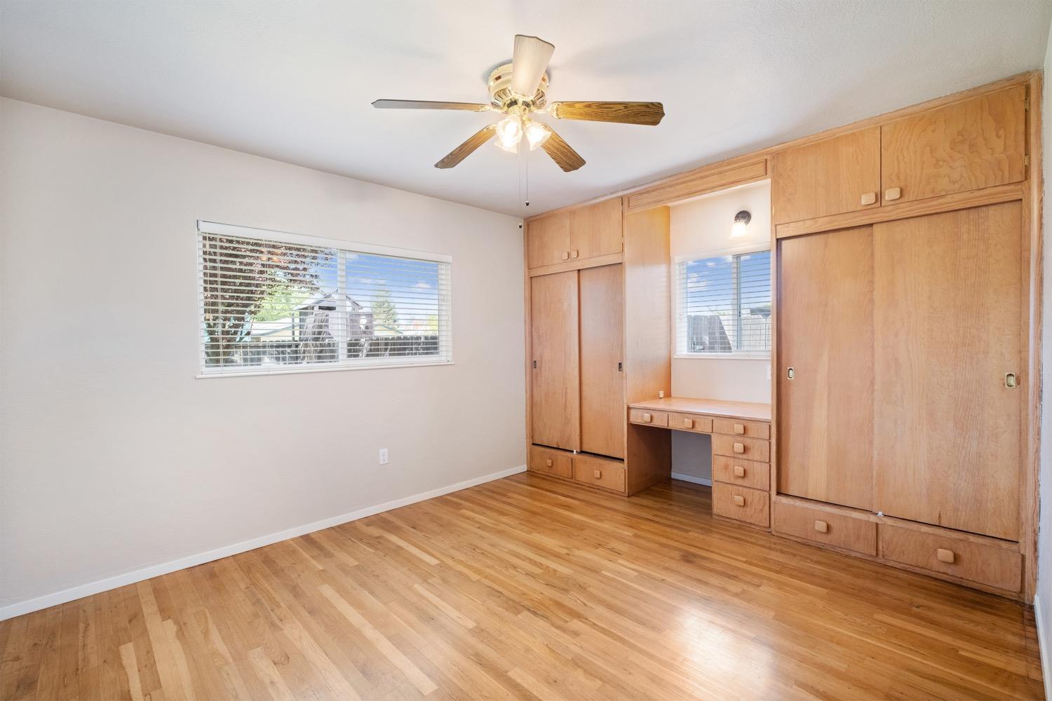 1223 Cyrier Avenue Reedley, CA 93654 - Photo 9 of 21 a bedroom with a bed and a chandelier