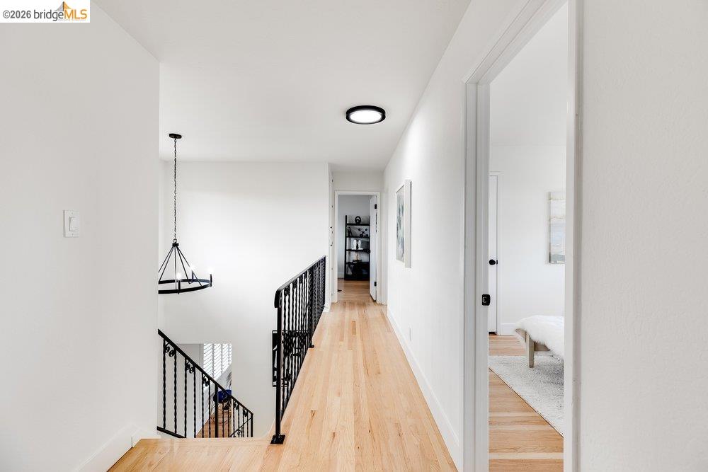 1298 Ribbon Street Foster City, CA 94404 - Photo 45 of 86 Upper-level hallway featuring wood-finish flooring, white walls, and contemporary ceiling light fixtures