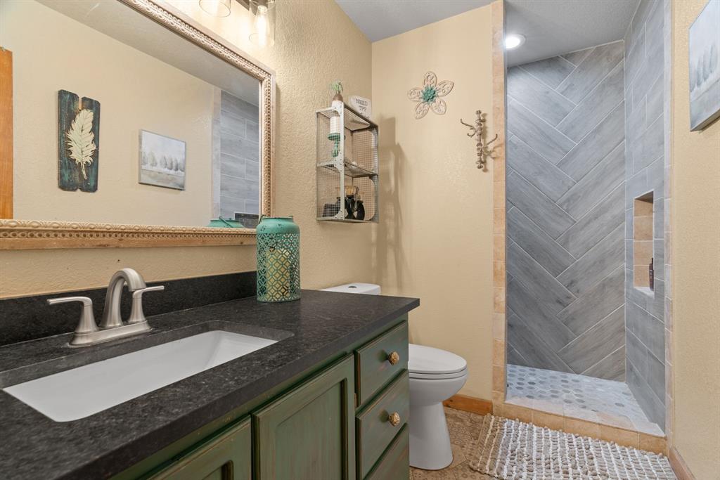 5058 West Highway 199 Springtown, TX 76082 - Photo 20 of 40 a bathroom with a sink and a mirror