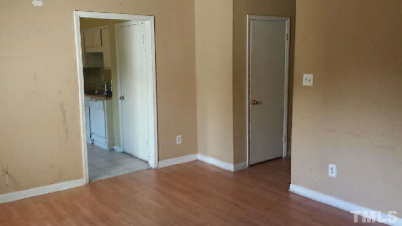 322 Junction Road, Unit 36A Durham, NC 27703 - Photo 2 of 10 a view of an empty room with closet and wooden floor