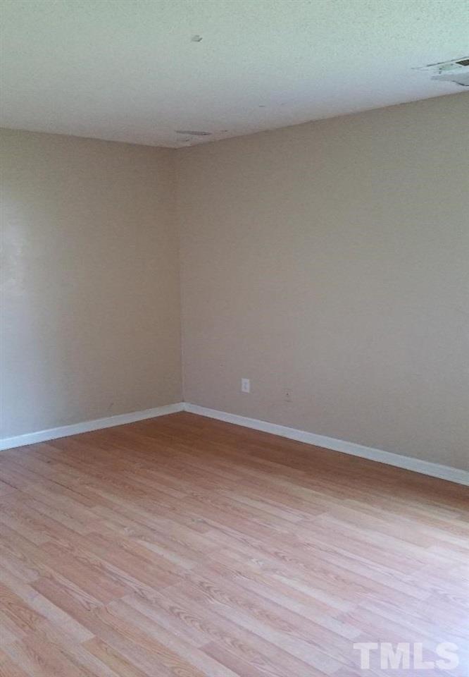 322 Junction Road, Unit 36A Durham, NC 27703 - Photo 7 of 10 a view of an empty room and wooden floor