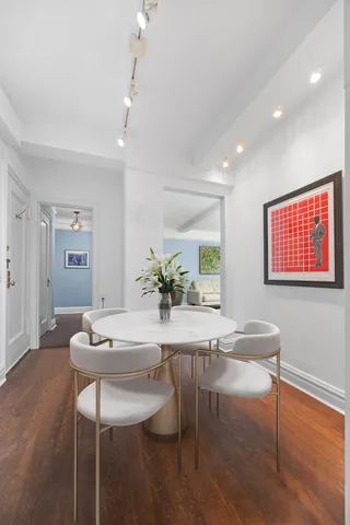a view of a dining room with furniture and wooden floor