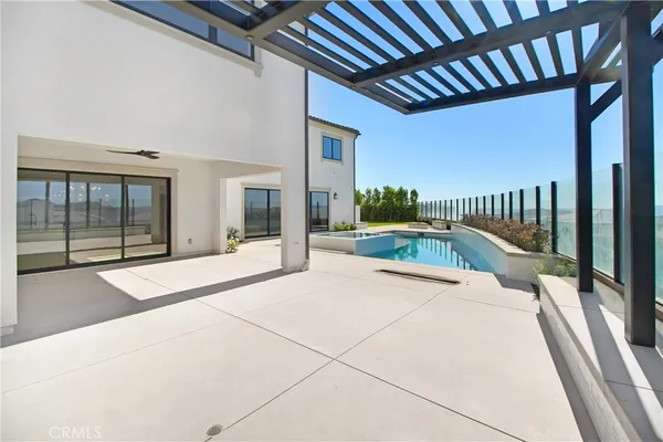 a swimming pool with potted plants in front of it