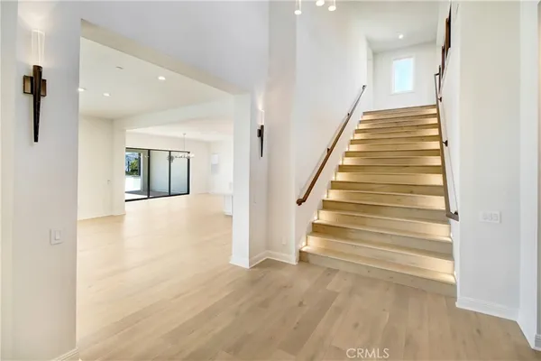 a view of entryway and hall with wooden floor