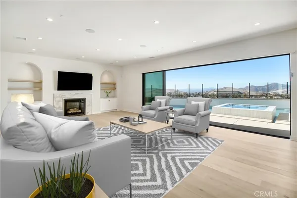 a living room with furniture a fireplace and a flat screen tv