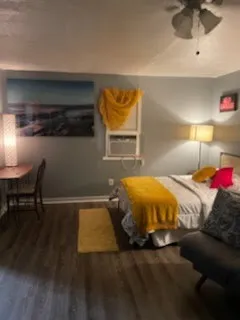 a bed sitting in a bedroom next to a lamp