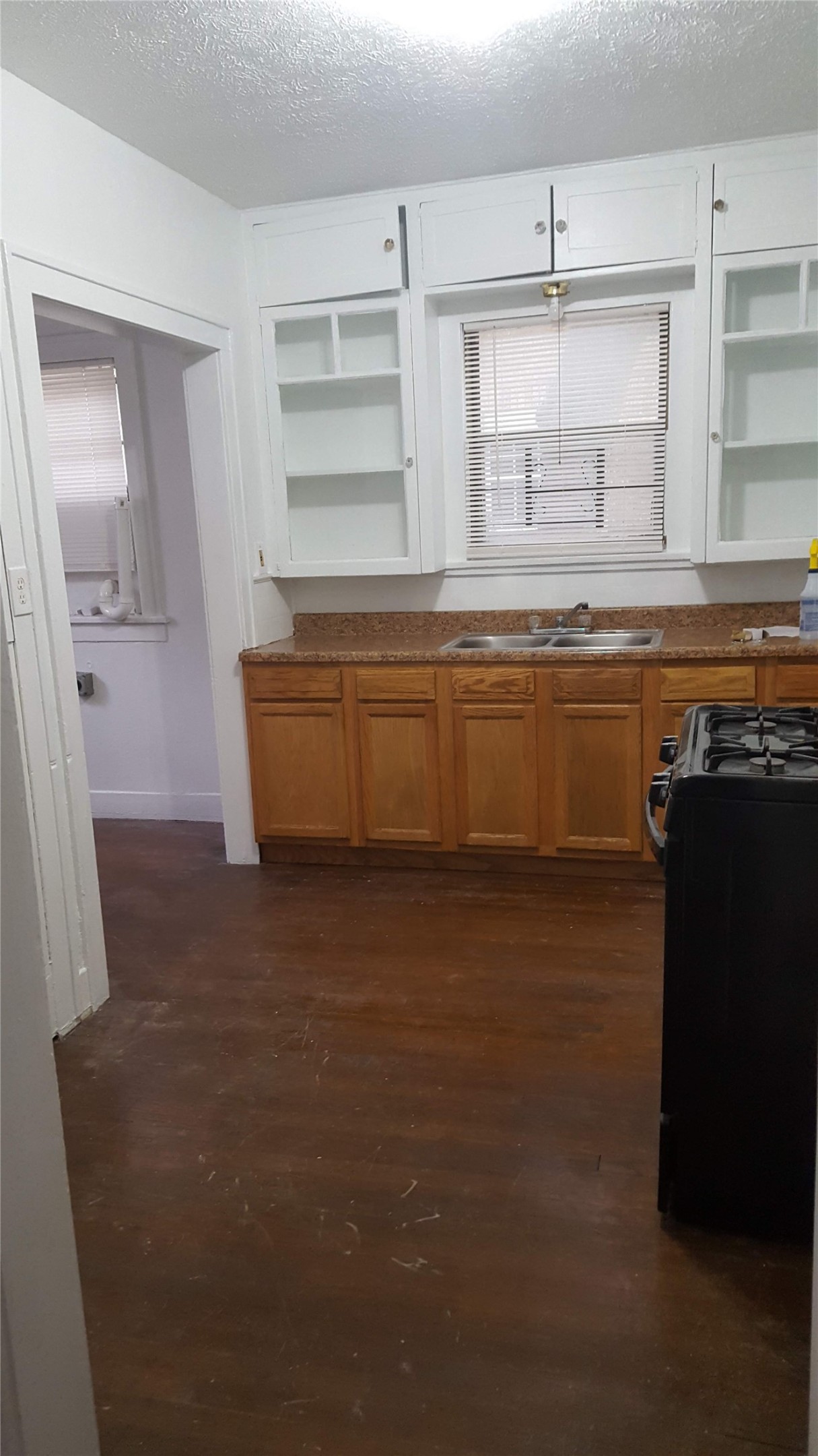 1828 Rosedale Street Houston, TX 77004 - Photo 21 of 32 a kitchen with kitchen island granite countertop a sink and a stove top oven