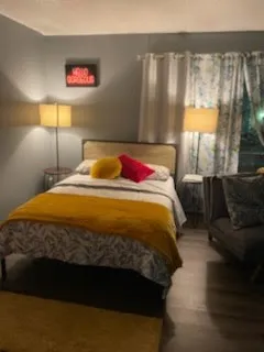 a bedroom with a bed and a lamp