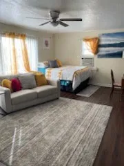 a spacious bedroom with a bed window and couch