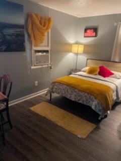 1828 Rosedale Street Houston, TX 77004 - Photo 10 of 13 a bedroom with a bed and wooden floor