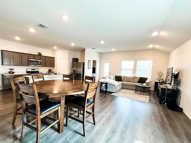 a view of a dining room with furniture and wooden floor