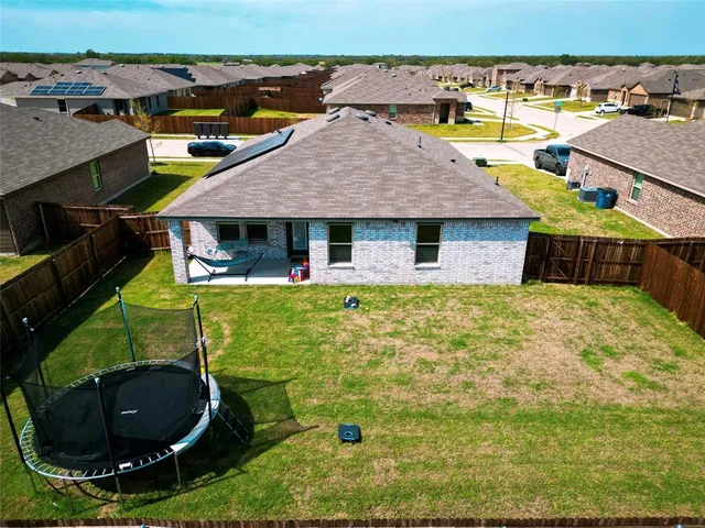 an aerial view of a house with garden space and outdoor seating