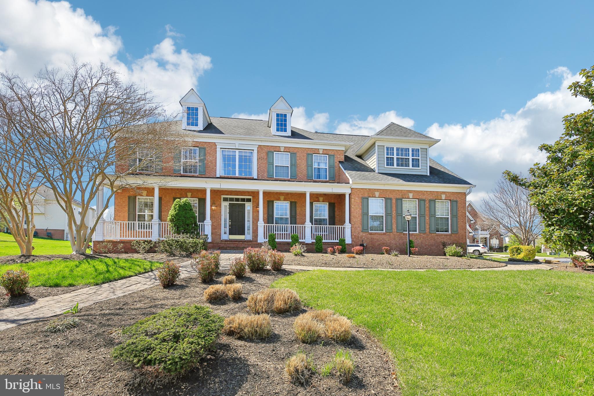 7020 Ironbridge Lane Laurel, MD 20707 - Photo 1 of 63 a front view of a house with a yard table and chairs