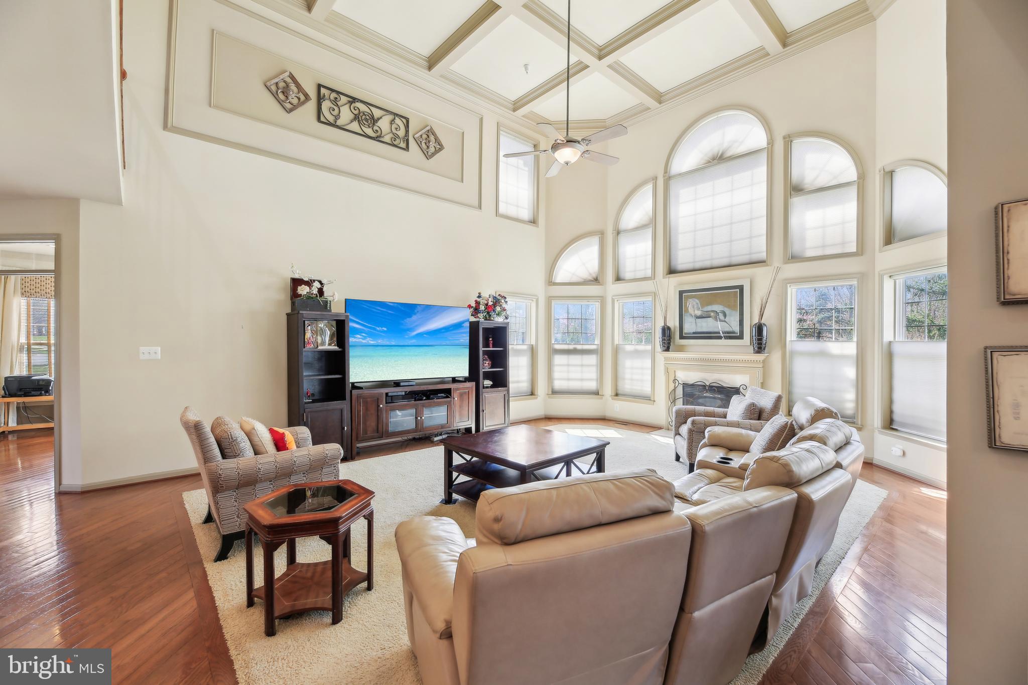 7020 Ironbridge Lane Laurel, MD 20707 - Photo 16 of 63 a living room with furniture a wooden floor and a chandelier