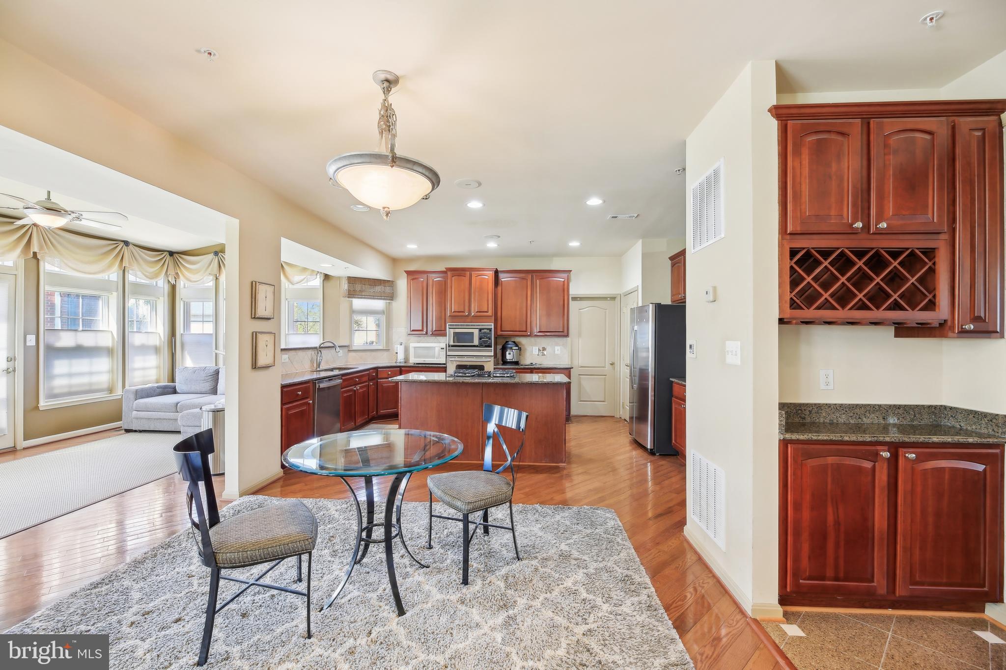 7020 Ironbridge Lane Laurel, MD 20707 - Photo 19 of 63 a view of a dining room with furniture window and wooden floor