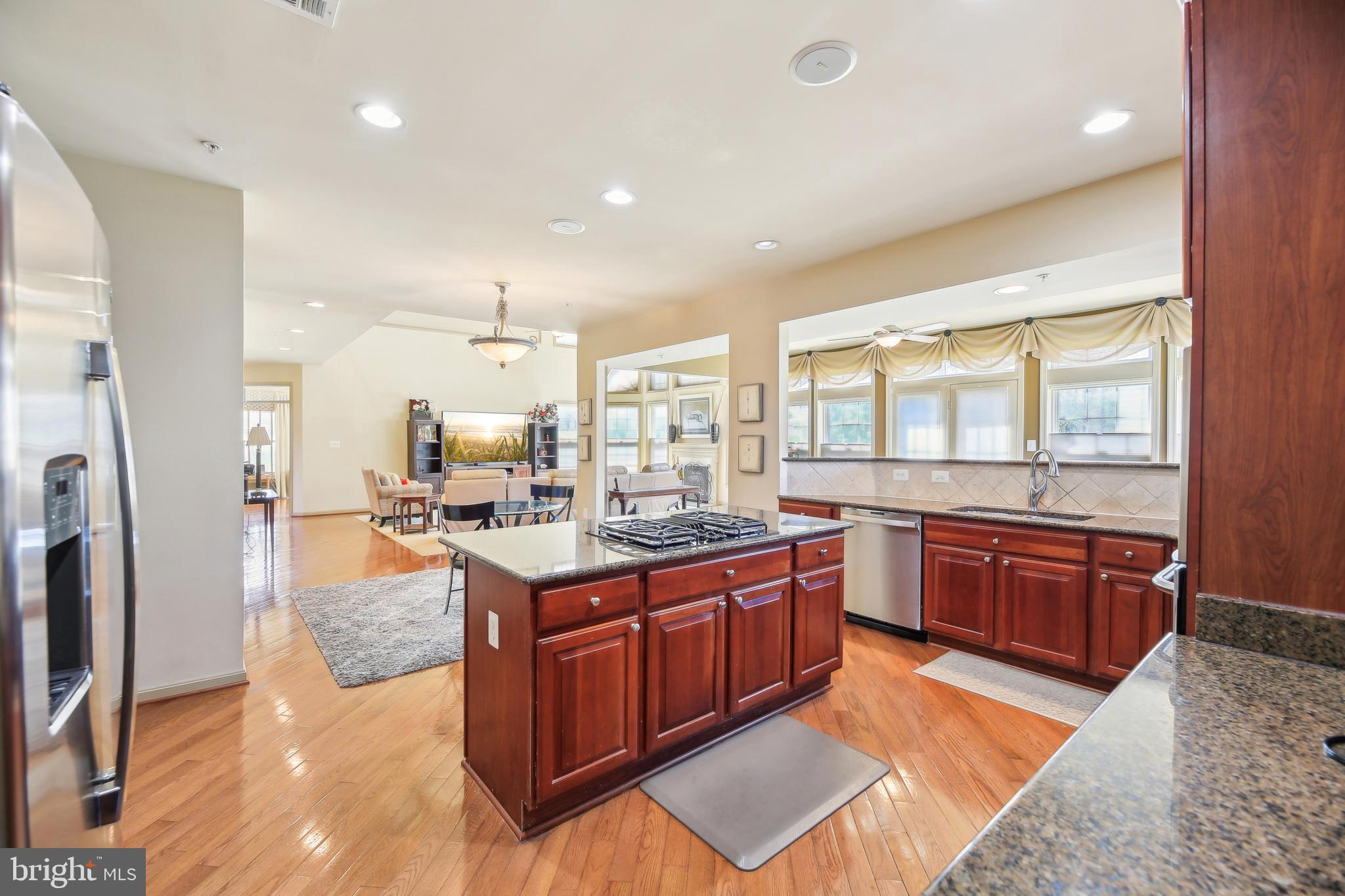 7020 Ironbridge Lane Laurel, MD 20707 - Photo 23 of 63 a large kitchen with stainless steel appliances granite countertop a stove a sink dishwasher and a refrigerator