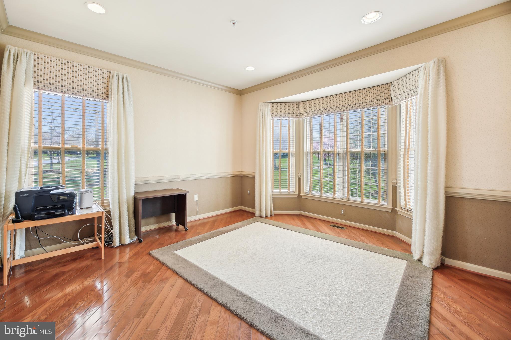 7020 Ironbridge Lane Laurel, MD 20707 - Photo 25 of 63 a spacious bedroom with a bed and a fireplace