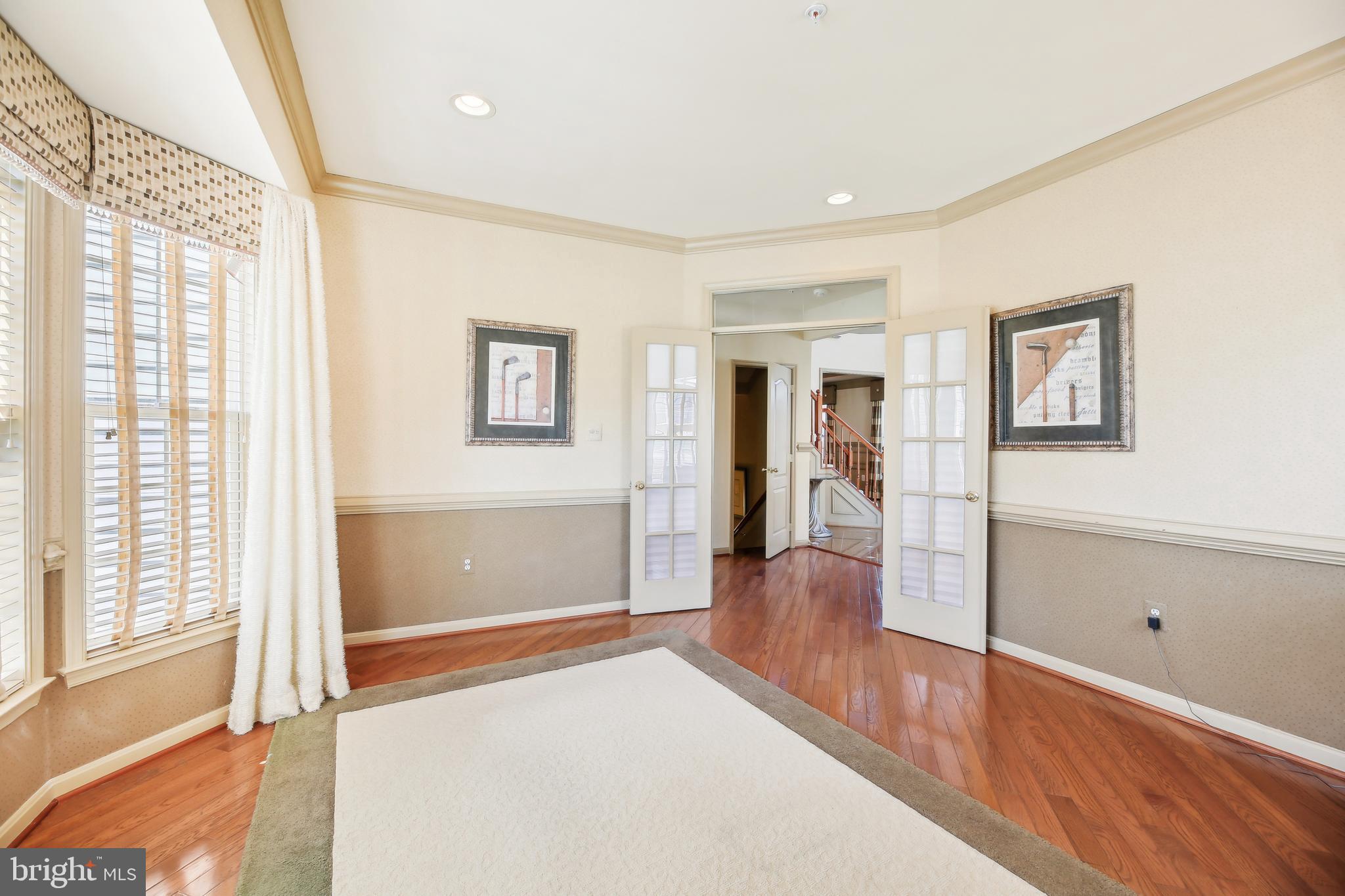 7020 Ironbridge Lane Laurel, MD 20707 - Photo 26 of 63 a view of a big room with wooden floor and windows