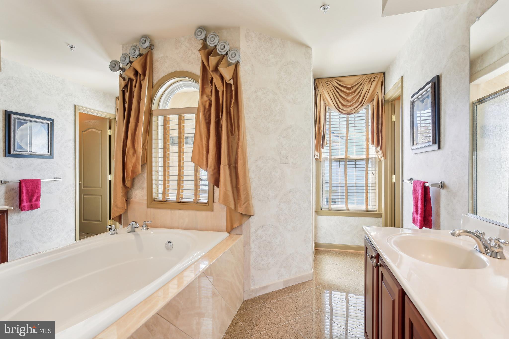 7020 Ironbridge Lane Laurel, MD 20707 - Photo 35 of 63 a bath room with a sink and a bathtub