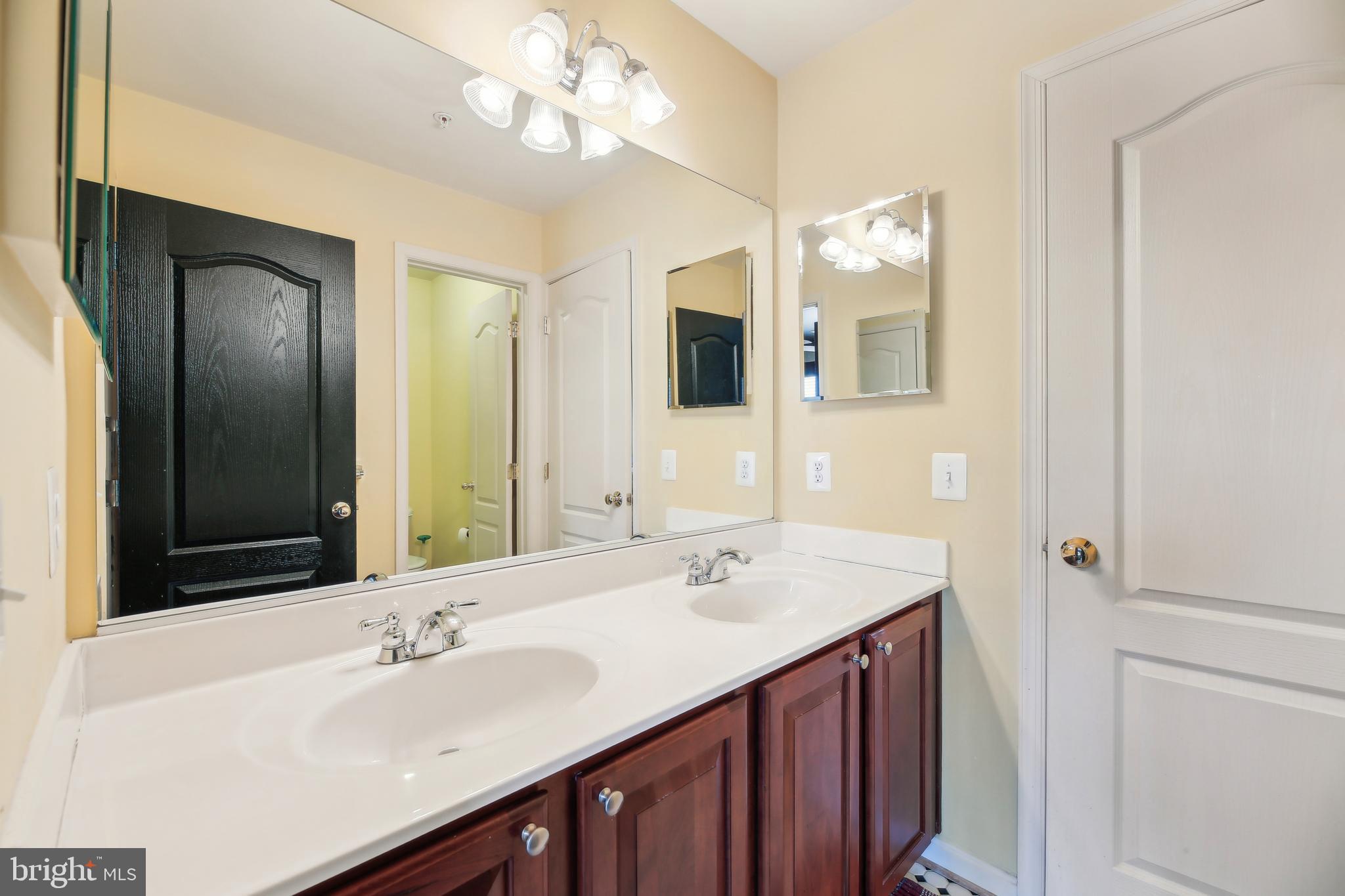 7020 Ironbridge Lane Laurel, MD 20707 - Photo 42 of 63 a bathroom with a sink double vanity and a mirror