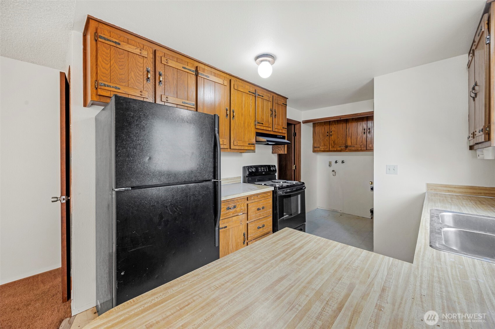 6920 Armar Road Marysville, WA 98270 - Photo 10 of 24 a kitchen with stainless steel appliances a refrigerator and a stove top oven