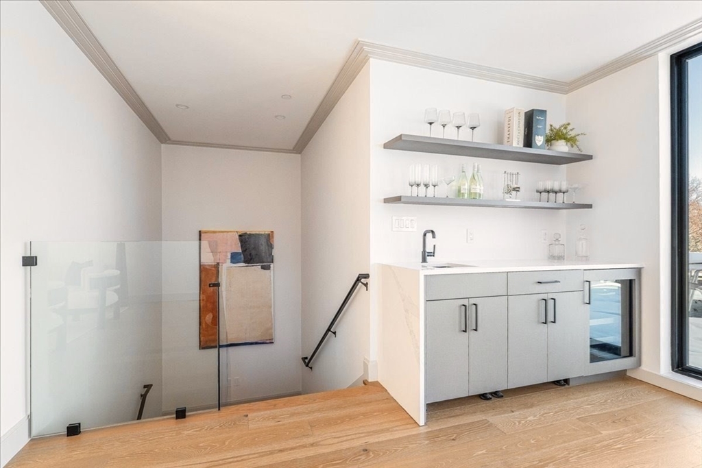 57 University Road, Unit 3 Brookline, MA 02445 - Photo 12 of 20 a bedroom with a bed and cabinets