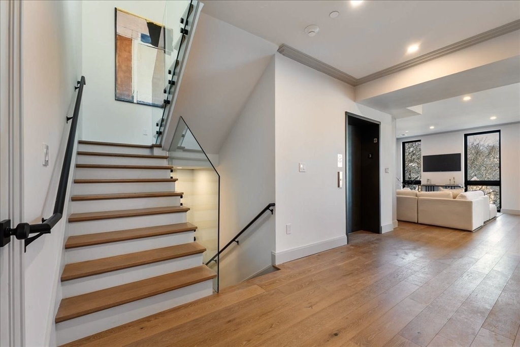 57 University Road, Unit 3 Brookline, MA 02445 - Photo 6 of 20 a view of a kitchen with furniture and an empty room