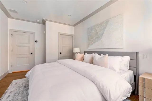 a bedroom with a bed and a mirror