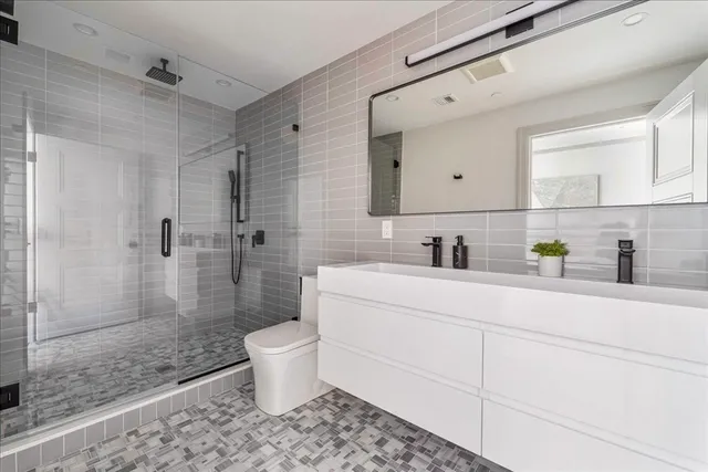 a bathroom with a sink toilet and shower