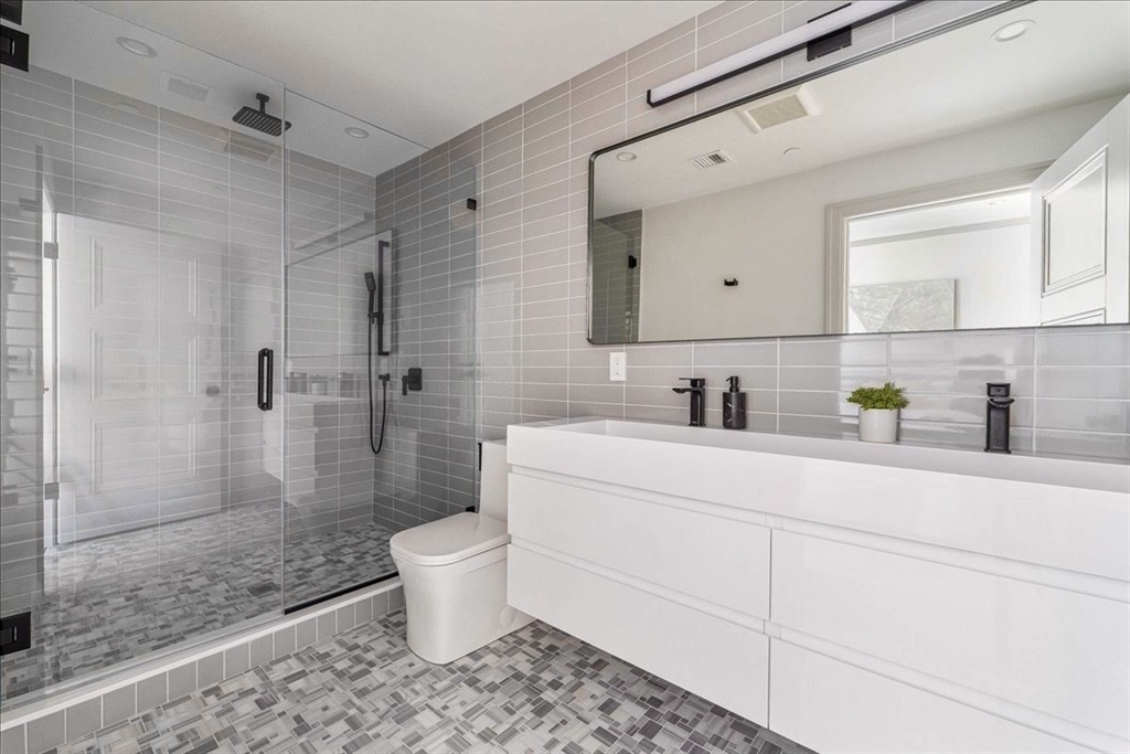 57 University Road, Unit 3 Brookline, MA 02445 - Photo 8 of 20 a bathroom with a sink toilet and shower