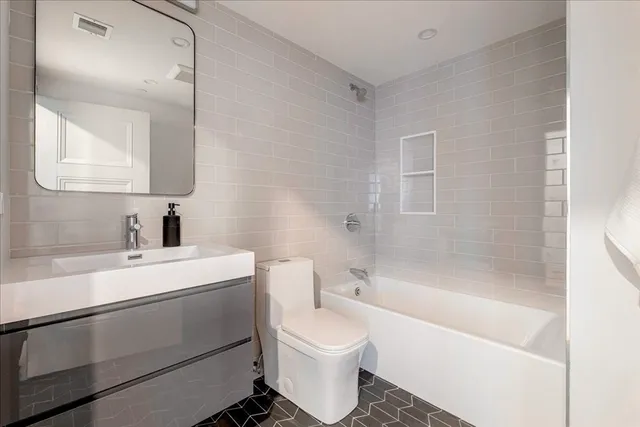 a bathroom with a sink a toilet and a bathtub