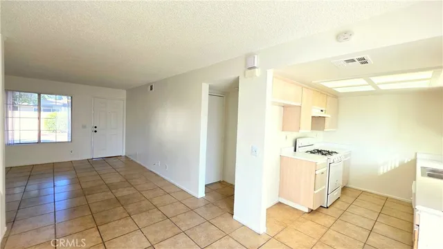 a view of a kitchen with wooden floor and a sink