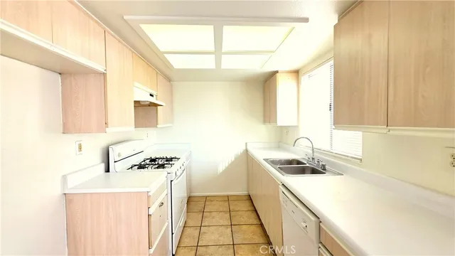 a kitchen that has a sink and a stove