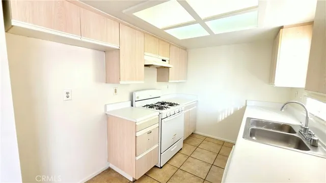 a kitchen with a sink stove and refrigerator