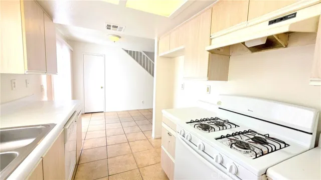 a kitchen with a stove a sink and a refrigerator