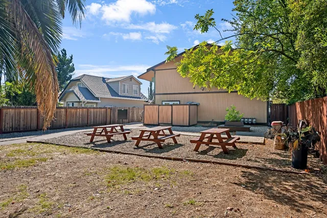 a view of a house with backyard and sitting area