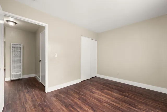 a view of a room with wooden floor