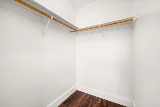 a kitchen with granite countertop stainless steel appliances a refrigerator and cabinets