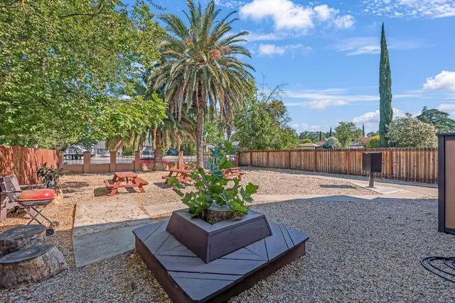 a backyard of a house with table and chairs