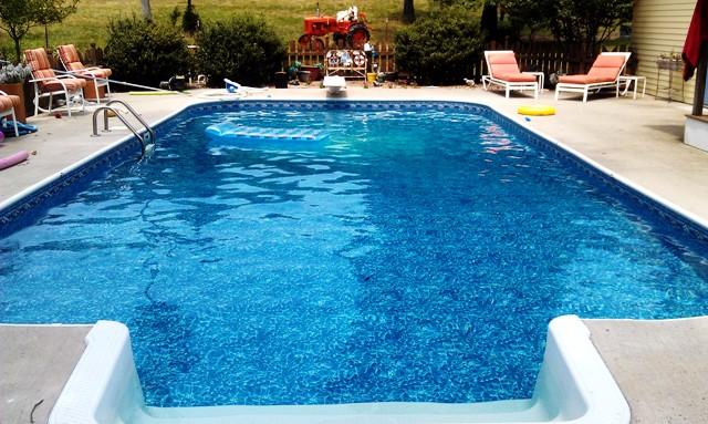 swimming pool view with a sitting space