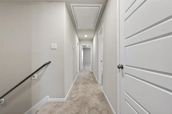 a bathroom with a glass shower door and a window