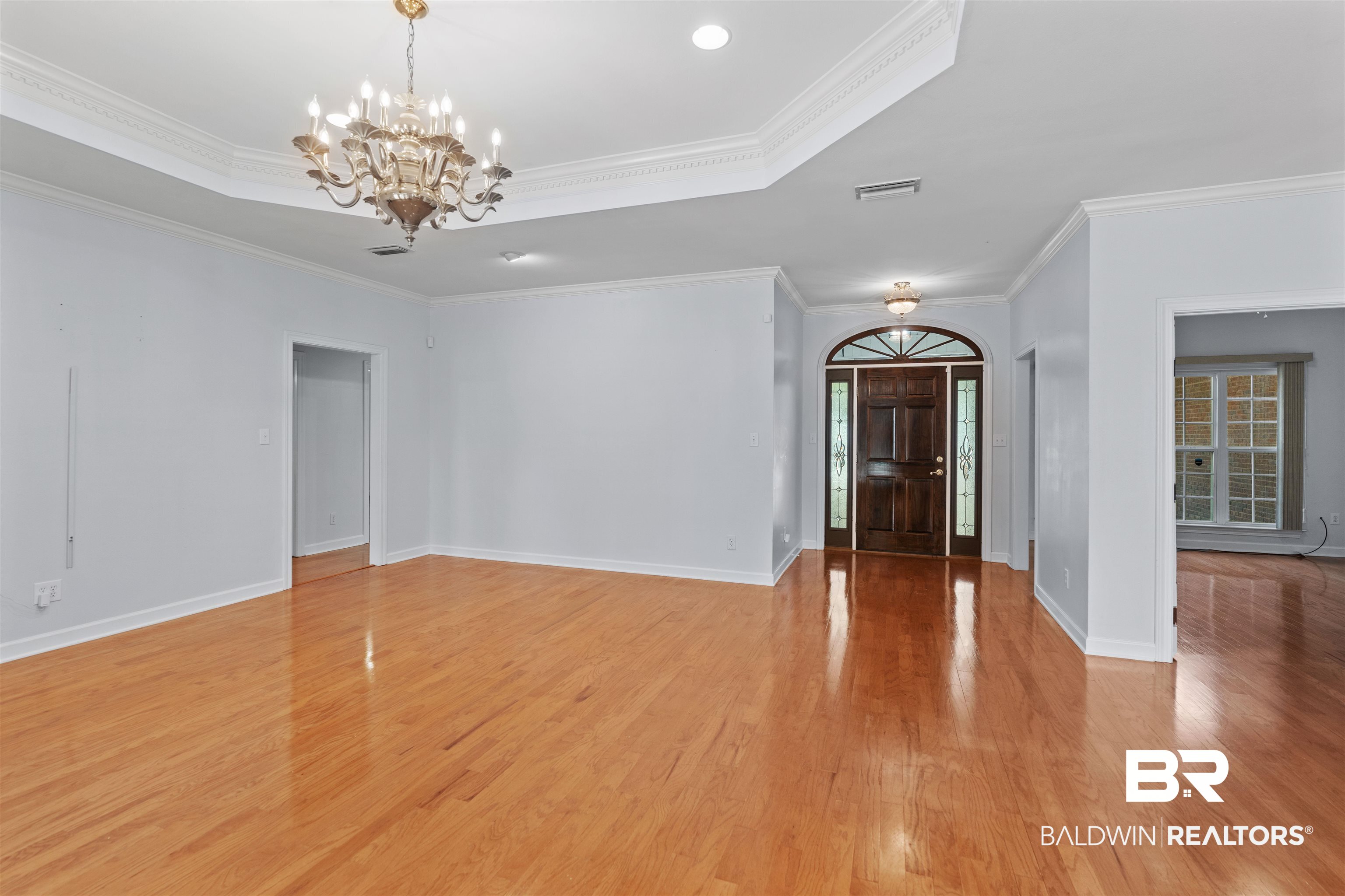 4 Judd Trail Daphne, AL 36527 - Photo 6 of 45 Entrance foyer featuring a notable chandelier, light wood-style flooring, and a tray ceiling