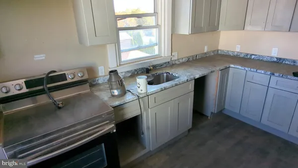 a kitchen with a sink cabinets and window