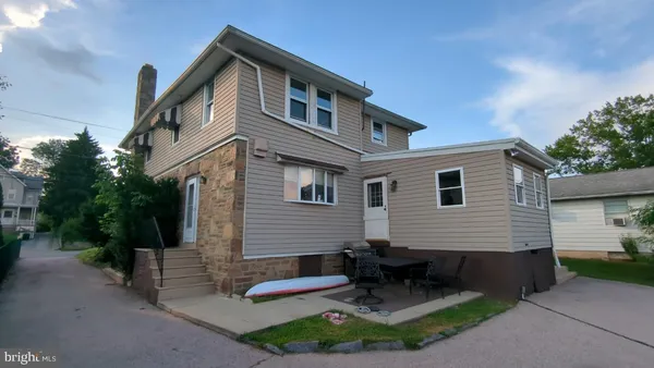 a front view of a house with a garden and plants