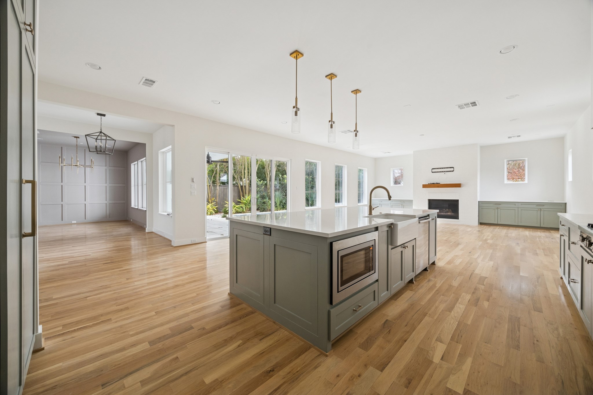 4219 Alba Road Houston, TX 77018 - Photo 11 of 39 a large white kitchen with wooden floors and stainless steel appliances