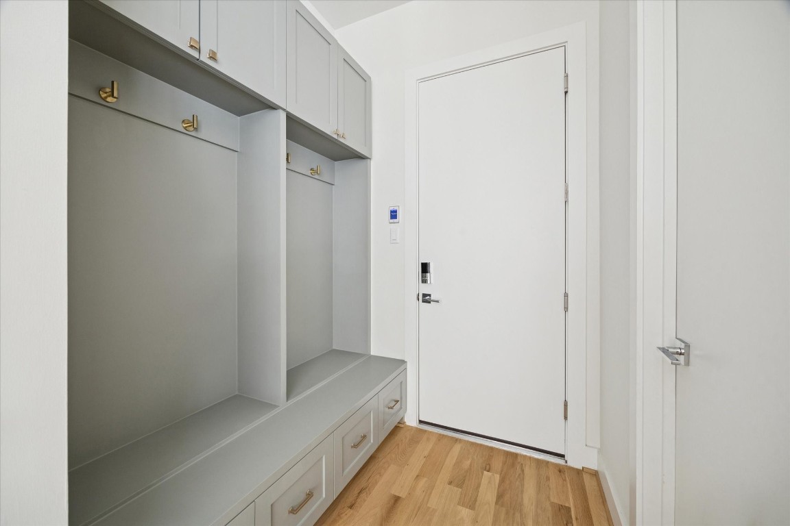 4219 Alba Road Houston, TX 77018 - Photo 17 of 39 Custom mudroom with built-in bench seating, upper cabinetry, brass hardware, and convenient storage near the main entry.