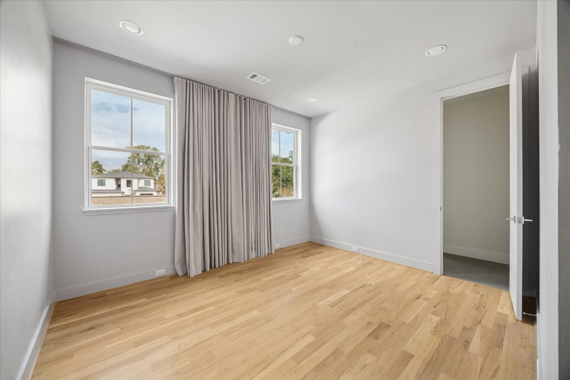 4219 Alba Road Houston, TX 77018 - Photo 27 of 39 Bright secondary bedroom with hardwood floors, recessed lighting, and dual windows dressed with custom drapery.